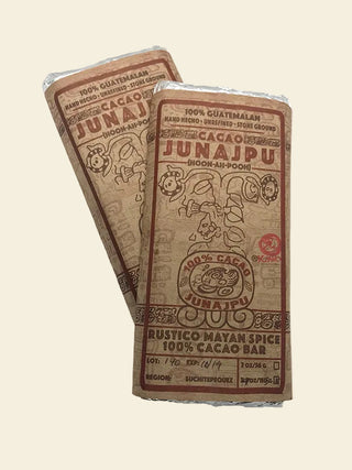 Two Junajpu chocolate bars wrapped in brown paper packaging on a white background