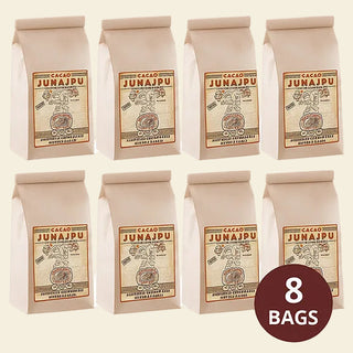 Eight bags of Junajpu Cacao on a white background